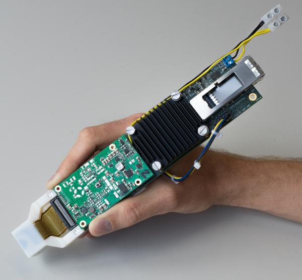 A hand holds the LightProbe (a hand-held ultrasound probe)